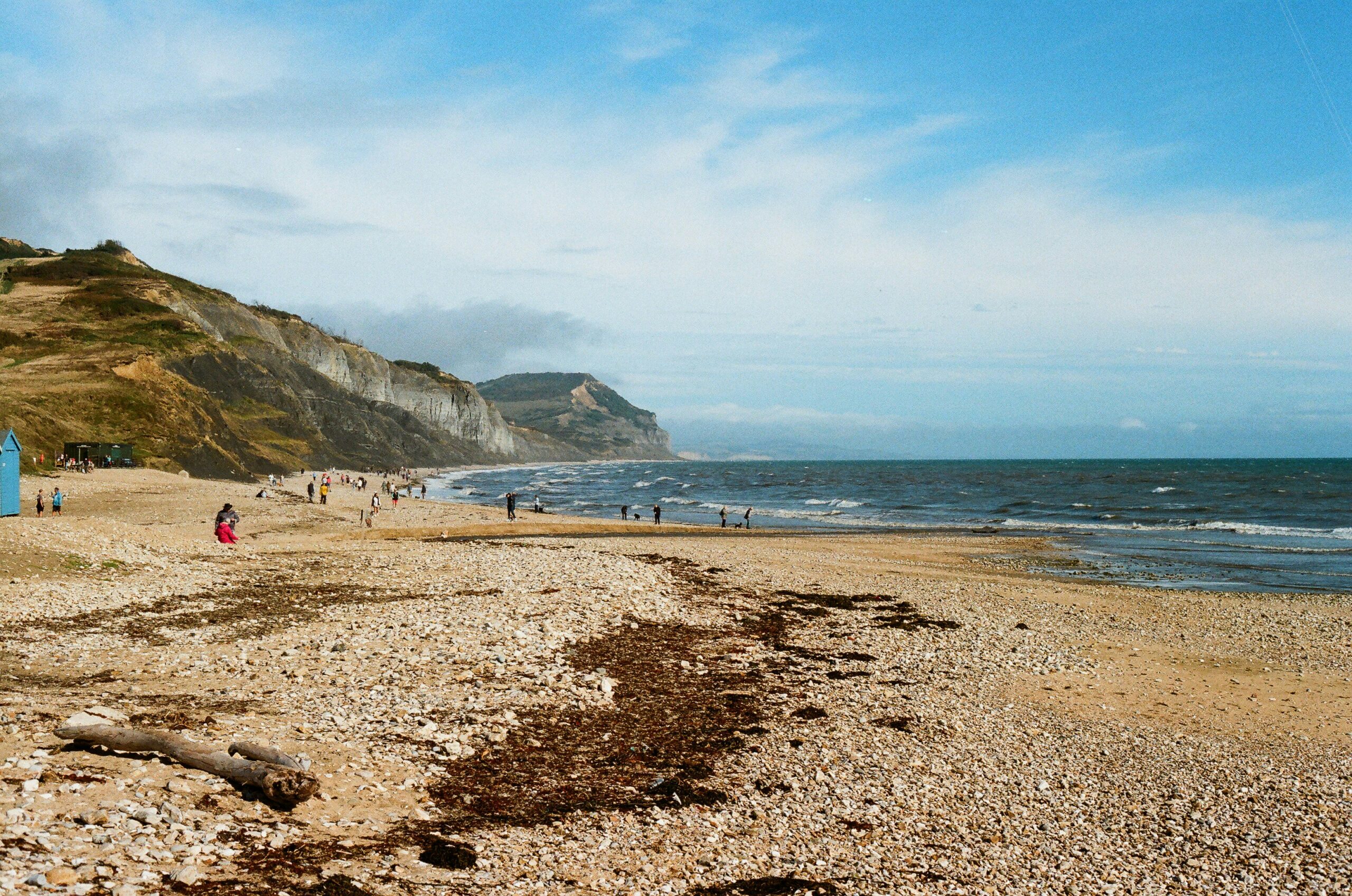 Dorset Jurassic Coast family summer day with cliffs, beach and children fossil hunting for